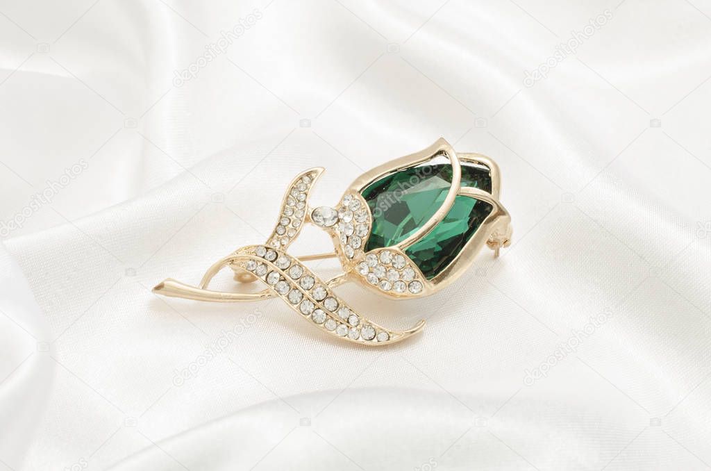 gold brooch rose bud with emerald and diamonds on silk