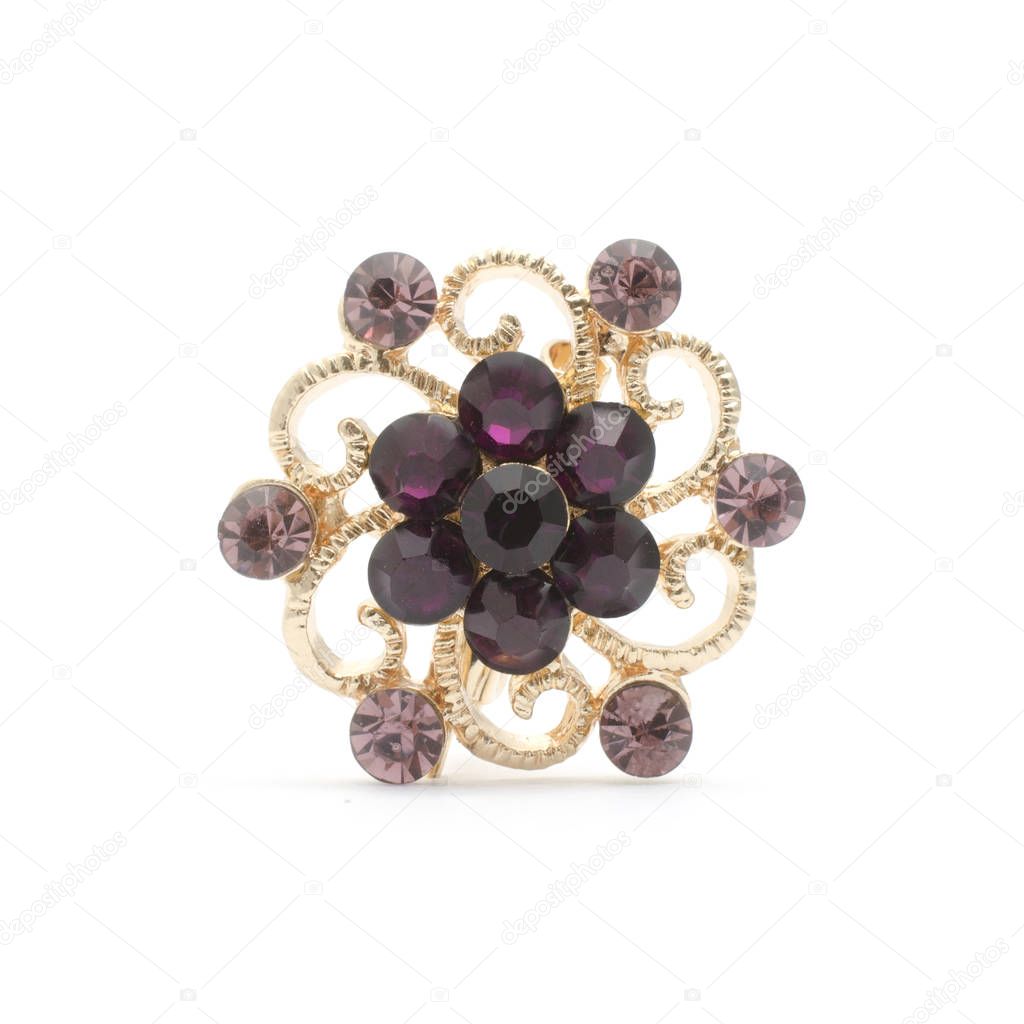 golden round brooch with purple diamonds isolated on white