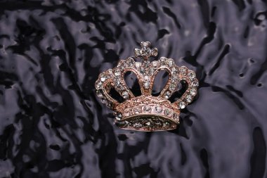 brooch golden crown in the water
