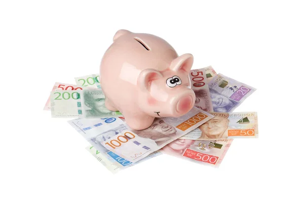 Piggy bank on Swedish cash — Stock Photo, Image