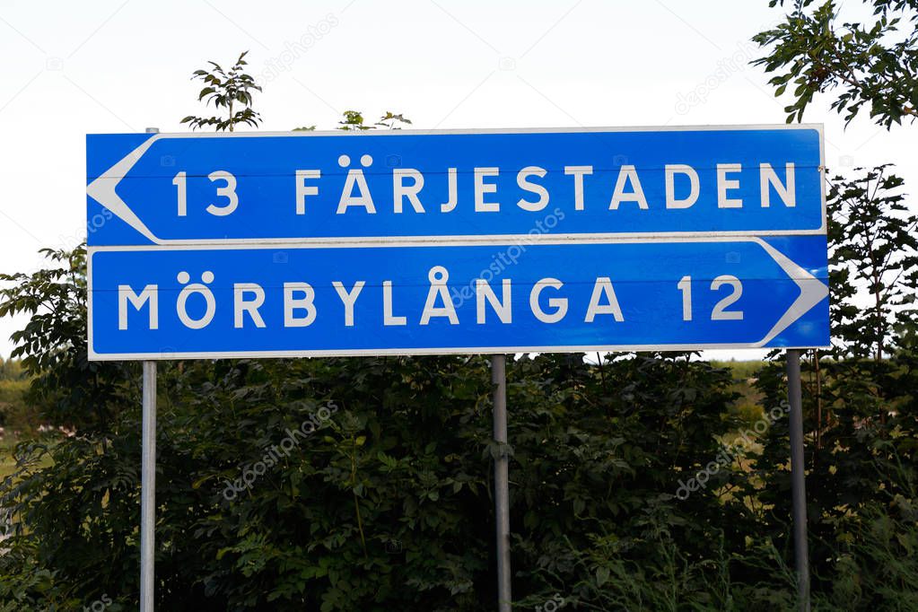 Signpost with distances to the two places Farjestaden and Morbylana located in the Swedish provice of Oland.