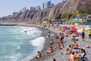 Crowded beach in Lima, Peru, district of Barranco. 2016-11-20. clipart