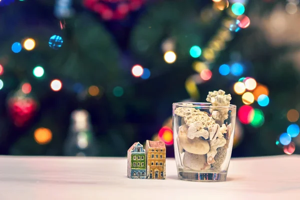 Conchas de mar, piedras y casas de colores en el fondo de Navidad — Foto de Stock