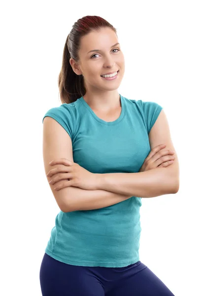 Beautiful fit girl standing with folded arms looking at camera — Stock Photo, Image