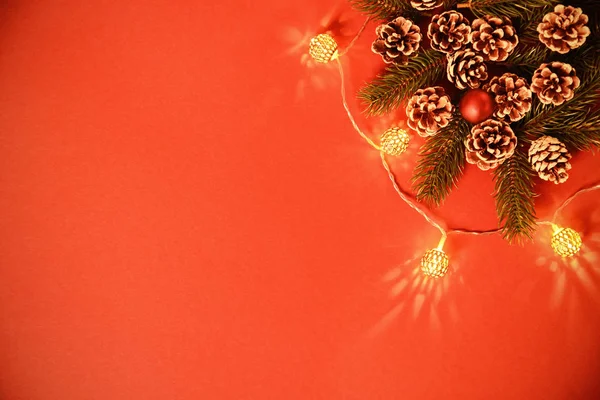 Greeting card concept with pinecones, branches and lights — Stock Photo, Image