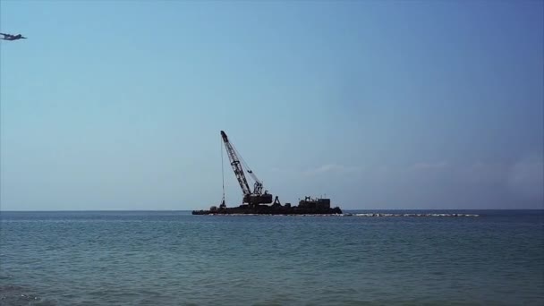 Crane on sea platform works. — Stock Video