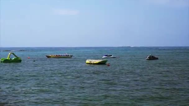 Water attractions: catamaran, jet ski, banana. — Stock Video