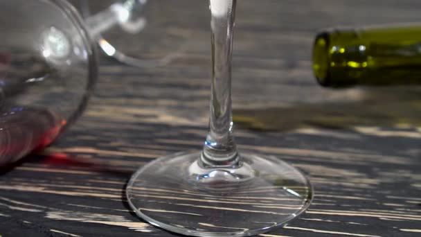 Corkscrew, cork, bottle and glass of red wine on a wooden table — Stock Video