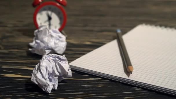 Person throwing a lot of crumpled paper on a desk, close-up. — Stock Video