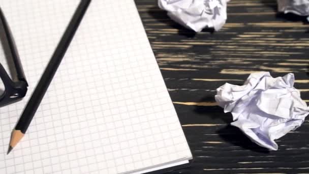 Person throwing a lot of crumpled paper on a desk, close-up. — Stock Video