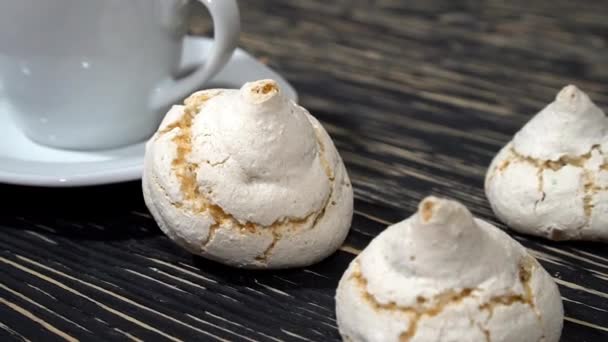 Lot of white meringue cakes with coffee — Stock Video
