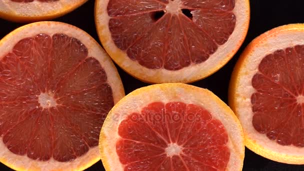 Rotating slices of grapefruit — Stock Video