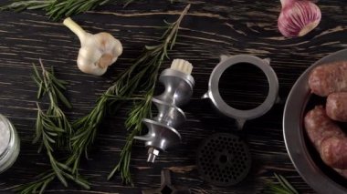 çiğ sosis, sarımsak, biberiye ve eski et kıyma makinesi parçaları