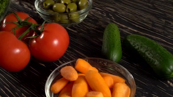 Vegetables ingridients for salad on rustic wooden background. — Stock Video