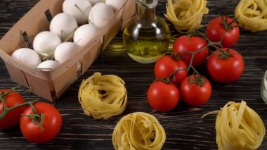 makarna, yumurta, yağ, domates ve sarımsak ahşap arka plan üzerinde