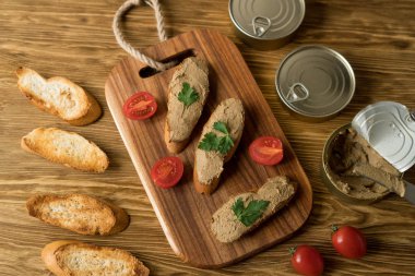Ekmek arası ahşap tepsi üzerinde karaciğer pate.