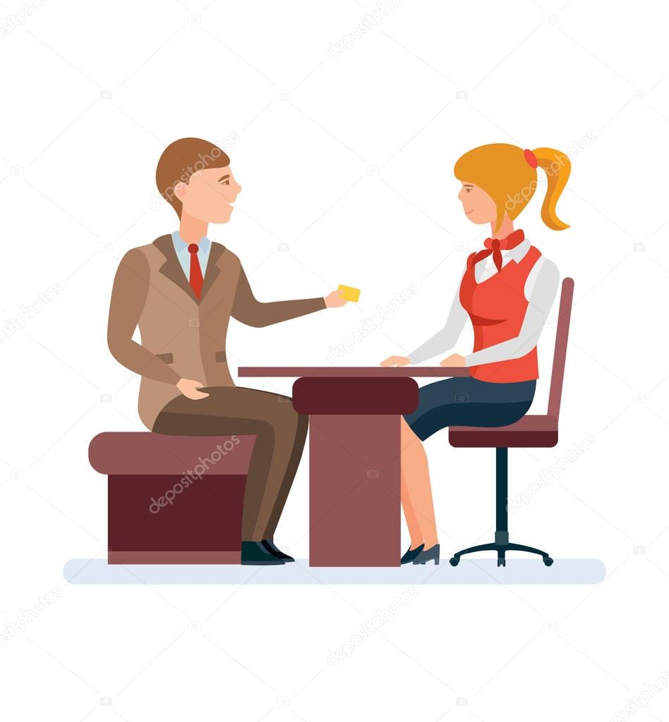 Manager, serves permanent client, with gold card behind office table.