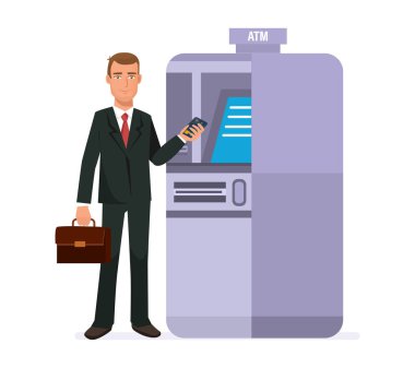 İşadamı kartından nakit para çekme için terminal yanında duruyor.
