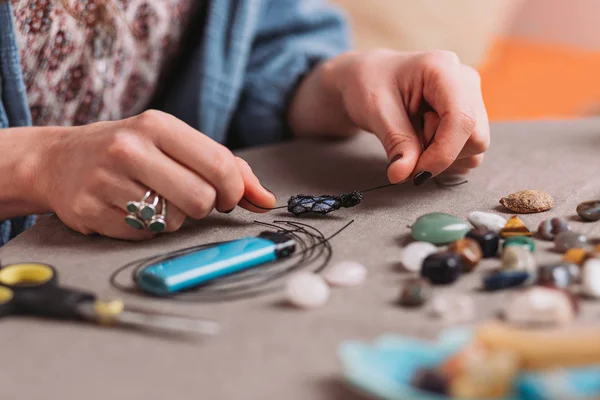 El yapımı mücevher yapan bir kadın, ev yapımı atölye çalışması. Zanaatkar kadın mücevher üretir. Sanat, hobi, el işi konsepti