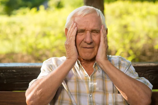 Elderly man has headache. — Stock Photo, Image