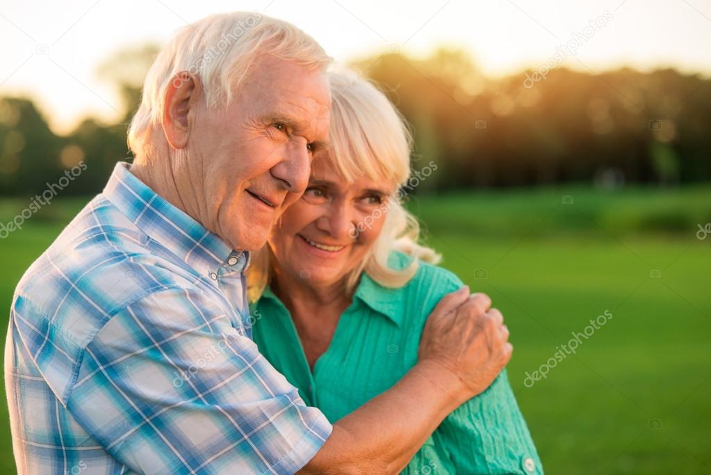 Senior man hugging woman.