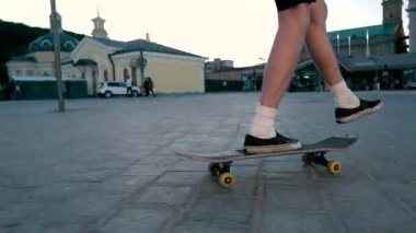 Bir kaykay üzerinde sürme bacaklar.