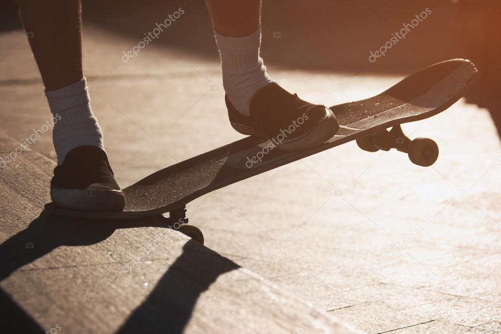 Feet on skateboard.