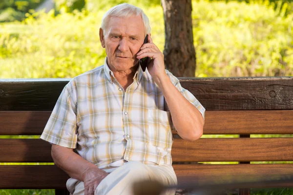 Elderly man on the phone.