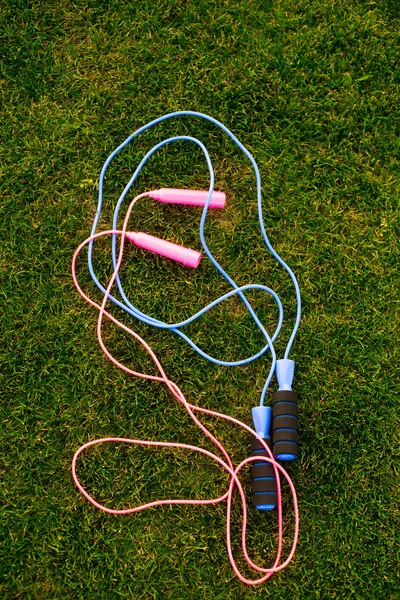 Jump ropes on grass.