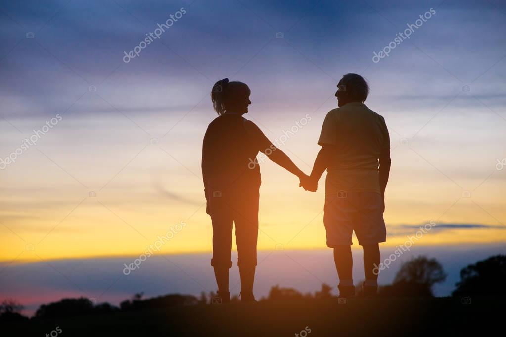 picture Sunset Two People Holding Hands Silhouette https depositphotos com 129034618 stock photo two people holding hands html