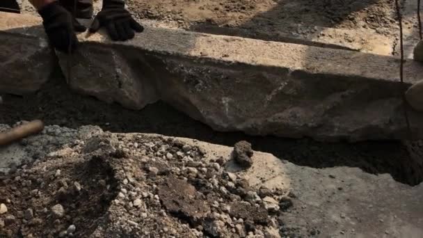 Hands of workers holding stone. — Stock Video