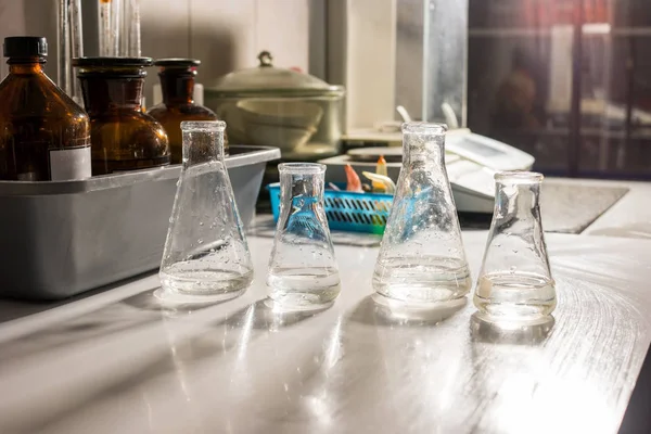 Beakers with transparent liquid. — Stock Photo, Image
