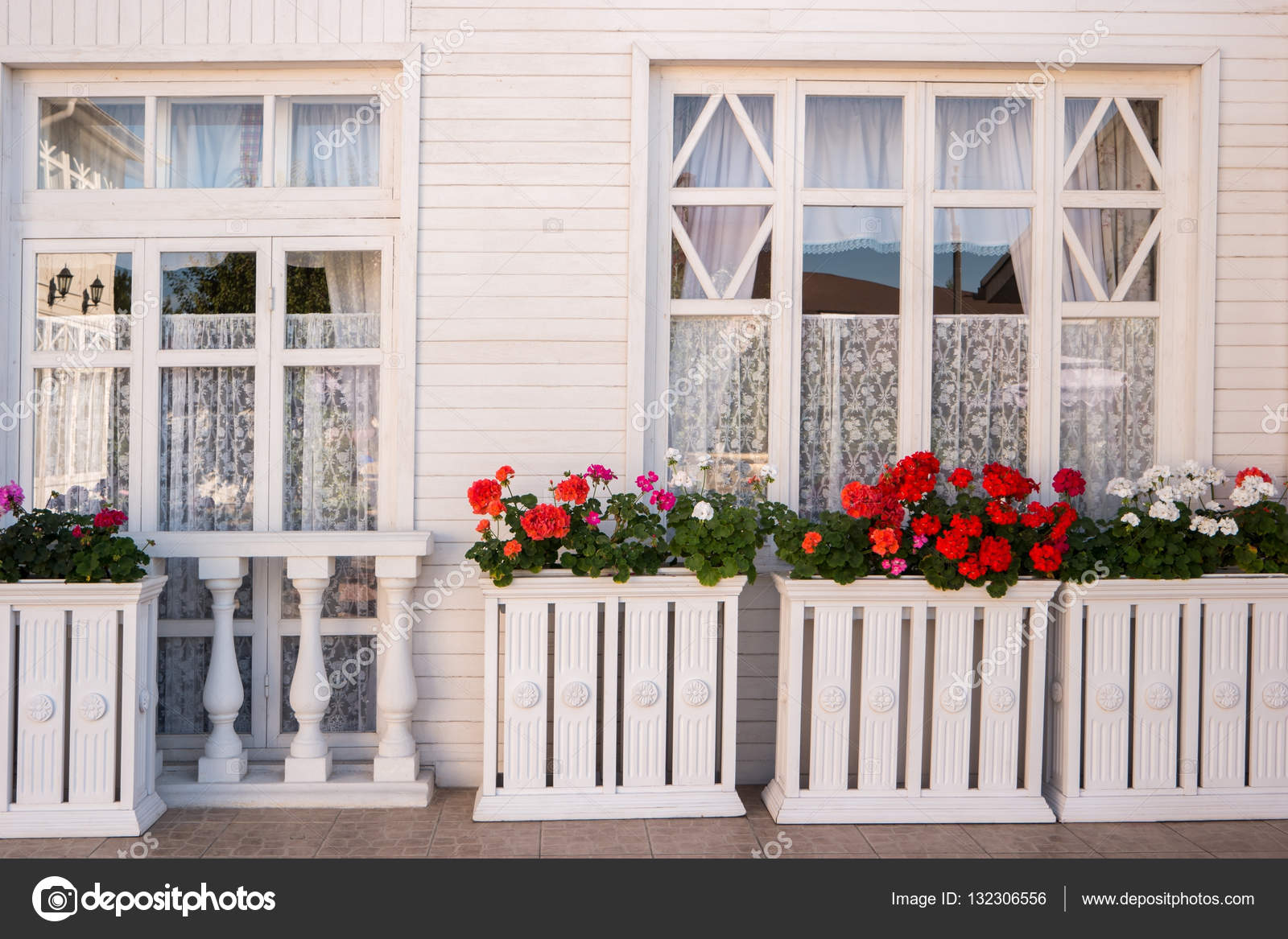 Flowers outside the house. \u2014 Stock Photo © Denisfilm 132306556