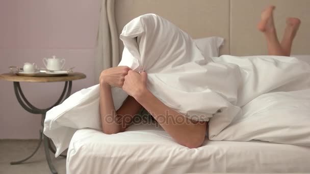 Woman hiding under blanket. — Stock Video
