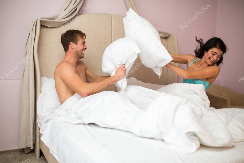 Pillow fight of a couple.