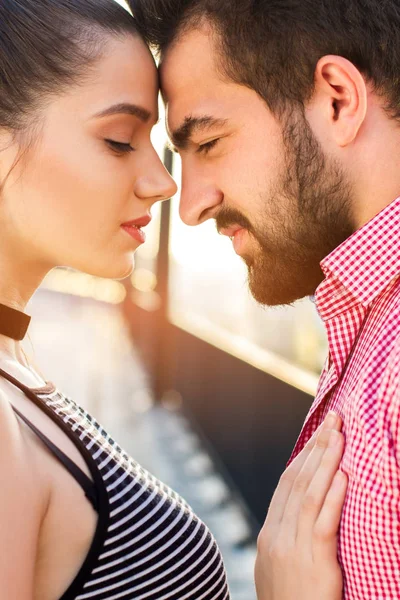 Couple is touching foreheads.