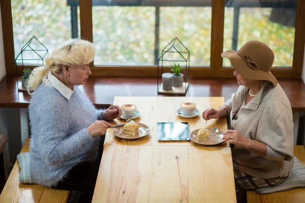 Пожилые женщины едят торт . — стоковое фото
