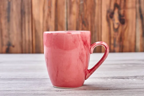Pink mug on wooden background. — Stock Photo, Image