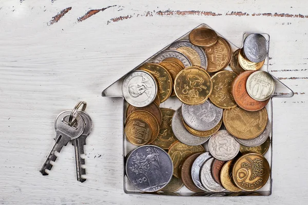 Coins in house-shaped form, keys.