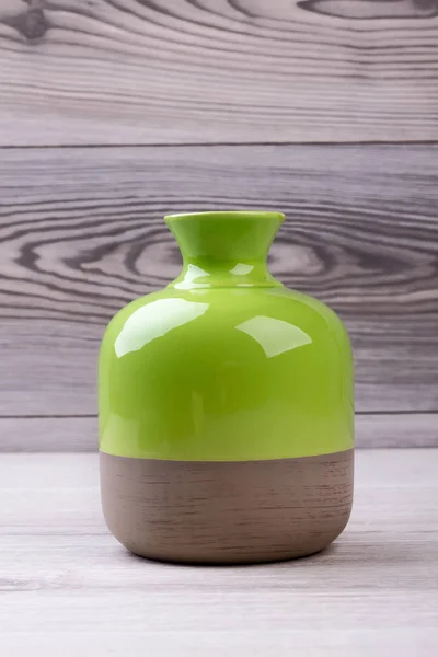 Bicolor vase on wooden background.
