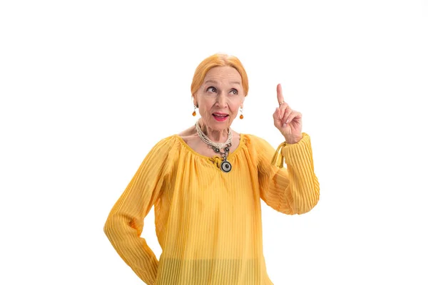 Senior woman with raised finger. — Stock Photo, Image