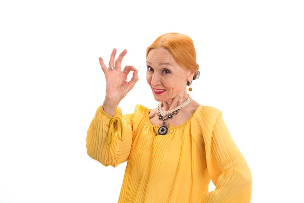 Senior woman showing ok gesture. — Stock Photo, Image