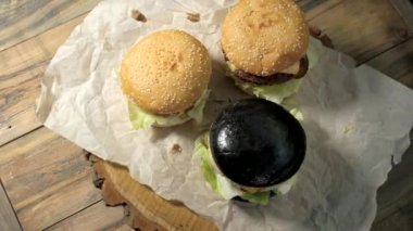 Ahşap zemin üzerinde üç hamburger.
