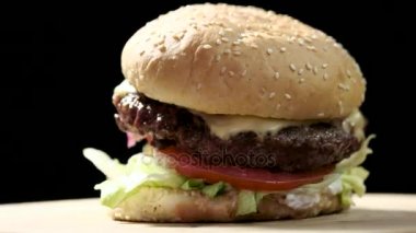 Siyah arka plan üzerine hamburger yakın çekim.