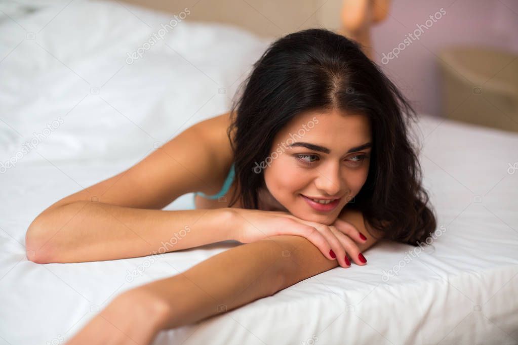 Female lying in bed.