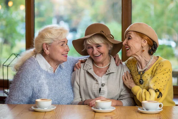 Senior women laughing at table. — Stock Photo, Image
