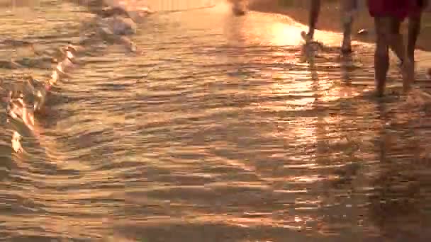 Les jambes des gens vont par la mer . — Video