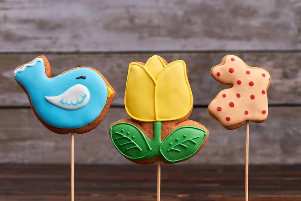 Three Easter biscuits on sticks.