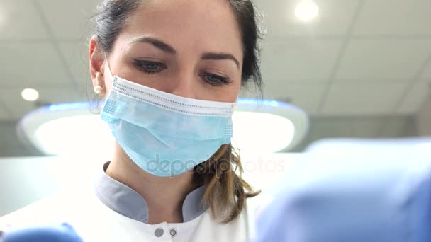 Young female stomatologist working. — Stock Video