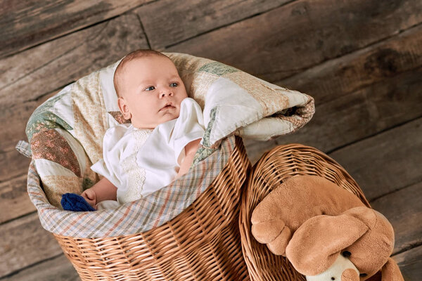 Baby boy in a basket.